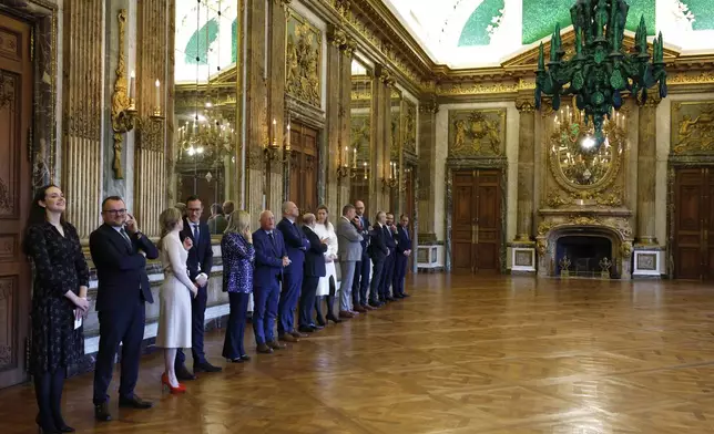 Government ministers stand in a line prior to a swearing in ceremony for the new Belgian government in front of Belgium's King Philippe at the Royal Palace in Brussels, Monday, Feb. 3, 2025. (AP Photo/Omar Havana)