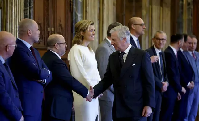 Belgium's King Philippe, center, shakes hands with Belgium's new Interior Minister Bernard Quintin during a swearing in ceremony for the new government at the Royal Palace in Brussels, Monday, Feb. 3, 2025. (AP Photo/Omar Havana)
