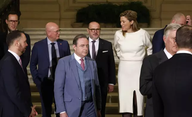 New Belgian Prime Minister Bart De Wever, center front, stands with other mininster prior to a group photo after a swearing in ceremony for the new government in front of Belgium's King Philippe at the Royal Palace in Brussels, Monday, Feb. 3, 2025. (AP Photo/Omar Havana)