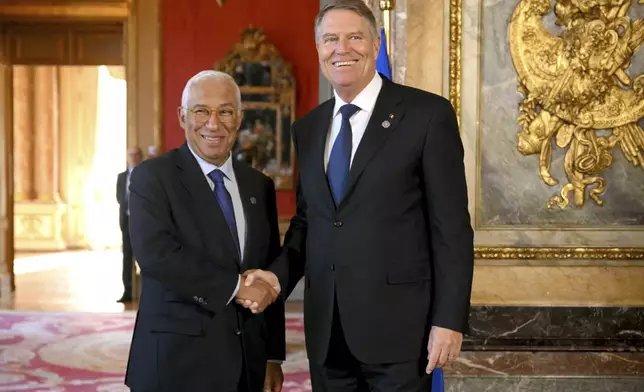 European Council President Antonio Costa, left, greets Romania's President Klaus Werner Ioannis as he arrives for an EU summit at the Egmont Palace in Brussels, Monday, Feb. 3, 2025. (Nicolas Tucat, Pool Photo via AP)