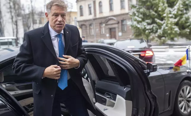 FILE - Romania's President Klaus Iohannis arrives in the symposium "The Idea of Europe" in Kaunas, Lithuania, Friday, Nov. 25, 2022. (AP Photo/Mindaugas Kulbis, File)