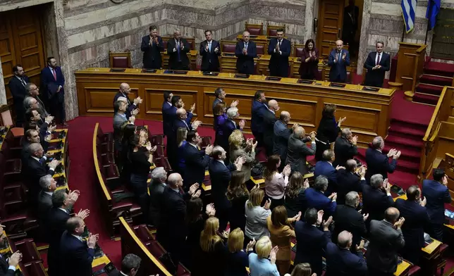 Lawmakers of the New Democracy's ruling party applaud after the election of former Parliament Speaker Constantine Tassoulas as Greece's new president at the Parliament, in Athens, Greece, Wednesday, Feb. 12, 2025. (AP Photo/Thanassis Stavrakis)