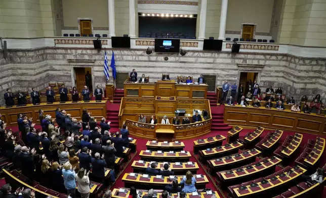 Lawmakers of the New Democracy's ruling party applaud after the election of former Parliament Speaker Constantine Tassoulas as Greece's new president at the Parliament, in Athens, Greece, Wednesday, Feb. 12, 2025. (AP Photo/Thanassis Stavrakis)