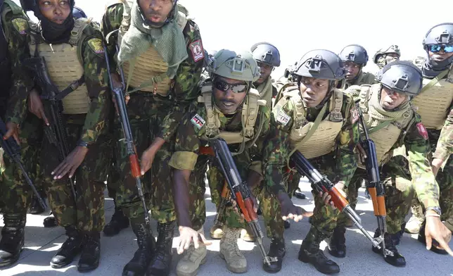 Kenyan police, who are part of a UN-backed multinational force, sing and dance on the tarmac after landing at the Toussaint Louverture International Airport in Port-au-Prince, Haiti, Thursday, Feb. 6, 2025. (AP Photo/Odelyn Joseph)