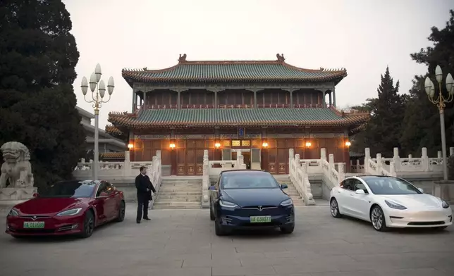 FILE - Tesla vehicles are parked outside of a building at the Zhongnanhai leadership compound during a meeting between Tesla CEO Elon Musk and former Chinese Premier Li Keqiang in Beijing, Wednesday, Jan. 9, 2019. (AP Photo/Mark Schiefelbein, Pool, File)