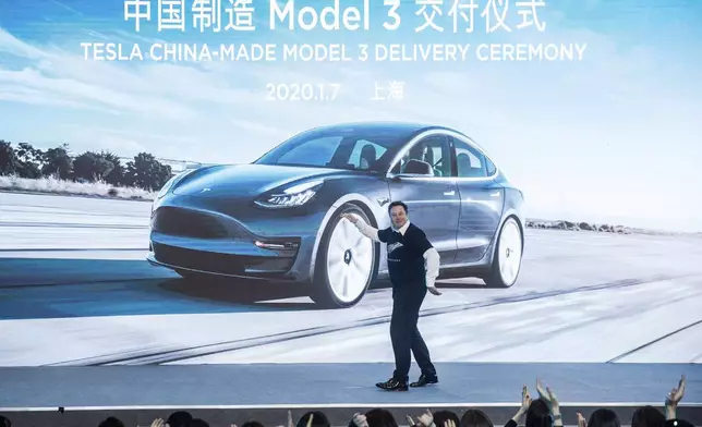 FILE - In this photo released by China's Xinhua News Agency, Tesla CEO Elon Musk reacts at a delivery ceremony for the first Tesla Model 3 cars made at Tesla's Shanghai factory in Shanghai, Tuesday, Jan. 7, 2020. (Ding Ting/Xinhua via AP, File)