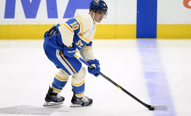 St. Louis Blues center Brayden Schenn (10) skates with the puck during the third period of an NHL hockey game against the Washington Capitals, Thursday, Feb. 27, 2025, in Washington. (AP Photo/Nick Wass)