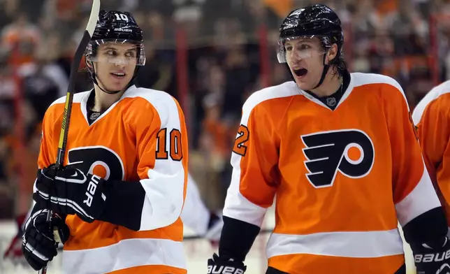 FILE - Philadelphia Flyers Brayden Schenn, left, looks towards his brother Luke, right, who shouts out after getting an assist on Max Talbot's goal in the second period of an NHL hockey game with the Washington Capitals, Feb 27, 2013, in Philadelphia. (AP Photo/Tom Mihalek, file)