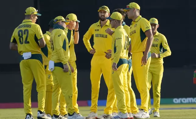 Australia's Steve Smith, third left, chats with teammates in a drink break during the ICC Champions Trophy cricket match between Australia and England, in Lahore, Pakistan, Saturday, Feb. 22, 2025. (AP Photo/K.M. Chaudary)