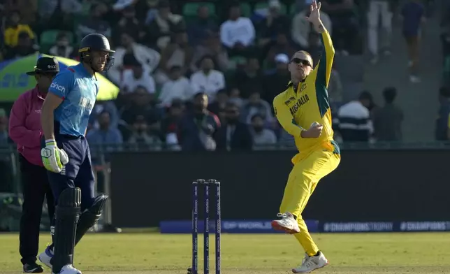 Australia's Adam Zampa, right, bowls as England's Jos Buttler watches during the ICC Champions Trophy cricket match between Australia and England, in Lahore, Pakistan, Saturday, Feb. 22, 2025. (AP Photo/K.M. Chaudary)