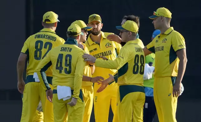Australia's Steve Smith, second left, and teammates celebrate after the dismissal of England's Jos Buttler during the ICC Champions Trophy cricket match between Australia and England, in Lahore, Pakistan, Saturday, Feb. 22, 2025. (AP Photo/K.M. Chaudary)