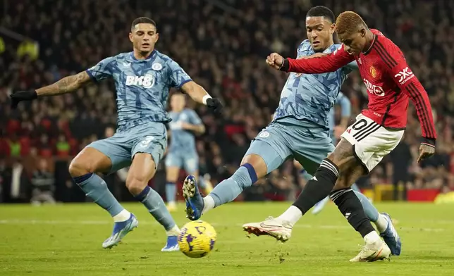 FILE - Manchester United's Marcus Rashford, right, shoots the ball during the English Premier League soccer match between Manchester United and Aston Villa at the Old Trafford stadium in Manchester, England, on Dec. 26, 2023. (AP Photo/Dave Thompson, File)
