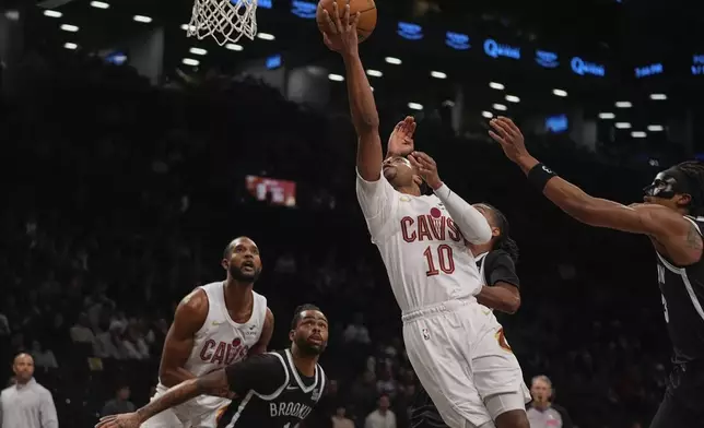 Cleveland Cavaliers' Darius Garland (10) drives past Brooklyn Nets' D'Angelo Russell (1) during the first half of an NBA basketball game Thursday, Feb. 20, 2025, in New York. (AP Photo/Frank Franklin II)