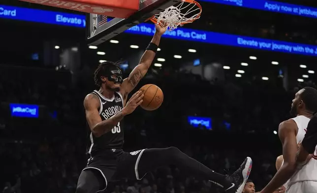 Brooklyn Nets' Nic Claxton (33) dunks the ball during the second half of an NBA basketball game against the Cleveland Cavaliers Thursday, Feb. 20, 2025, in New York. (AP Photo/Frank Franklin II)
