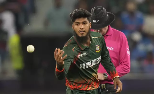 Bangladesh's Rishad Hossain prepares to bowl his next delivery during the ICC Champions Trophy cricket match between India and Bangladesh at Dubai International Cricket Stadium in Dubai, United Arab Emirates, Thursday, Feb. 20, 2025. (AP Photo/Altaf Qadri)