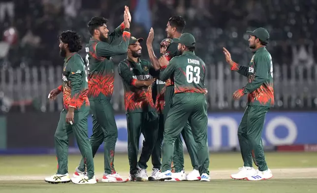 Bangladesh's Nahid Rana, center, celebrates with teammates after taking the wicket of New Zealand's Kane Williamson during the ICC Champions Trophy cricket match between Bangladesh and New Zealand, in Rawalpindi, Pakistan Monday, Feb. 24, 2025,. (AP Photo/Anjum Naveed)