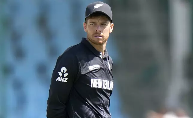 New Zealand's Mitchel Santner waits for coin toss before the start the ICC Champions Trophy cricket match between Pakistan and New Zealand, in Karachi, Pakistan Wednesday, Feb. 19, 2025. (AP Photo/Anjum Naveed)
