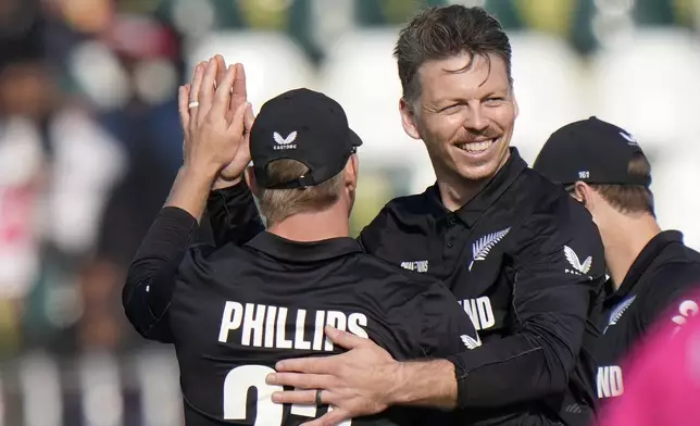 New Zealand's Michael Bracewell, right, celebrates with teammates after taking the wicket of Bangladesh's Mushfiqur Rahim during the ICC Champions Trophy cricket match between Bangladesh and New Zealand, in Rawalpindi, Pakistan Monday, Feb. 24, 2025,. (AP Photo/Anjum Naveed)