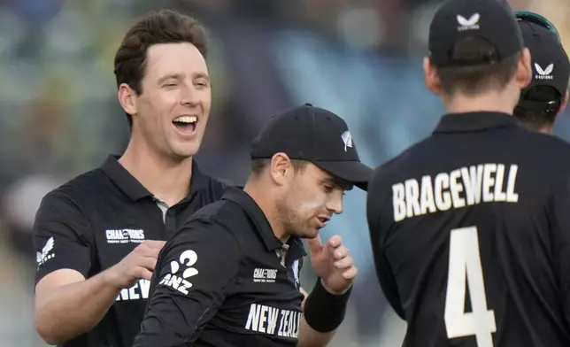 New Zealand's Matt Henry, left, and teammates celebrate after the dismissal of Bangladesh's Rishad Hossain during the ICC Champions Trophy cricket match between Bangladesh and New Zealand, in Rawalpindi, Pakistan Monday, Feb. 24, 2025,. (AP Photo/Anjum Naveed)