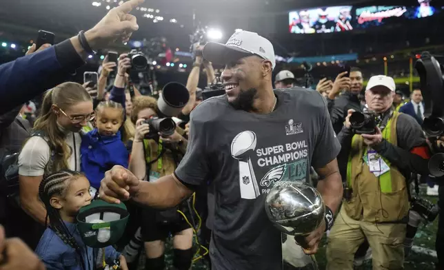 Philadelphia Eagles running back Saquon Barkley celebrates with the Vince Lombardi Trophy after a win over the Kansas City Chiefs in the NFL Super Bowl 59 football game, Sunday, Feb. 9, 2025, in New Orleans. (AP Photo/Matt Slocum)