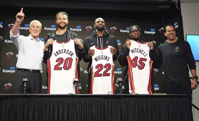 Pat Riley, president of the Miami Heat basketball team, left, and head coach Erik Spoelstra, right, pose with newly signed players Kyle Anderson (20), Andrew Wiggins (22) and Davion Mitchell (45) during a news conference Sunday, Feb. 9, 2025, in Miami. (AP Photo/Lynne Sladky)