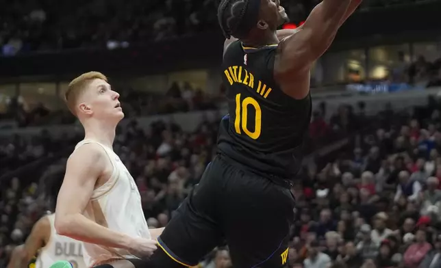 Golden State Warriors forward Jimmy Butler (10) goes up to shoot during the second half of an NBA basketball game against the Chicago Bulls, Saturday, Feb. 8, 2025, in Chicago. (AP Photo/Erin Hooley)