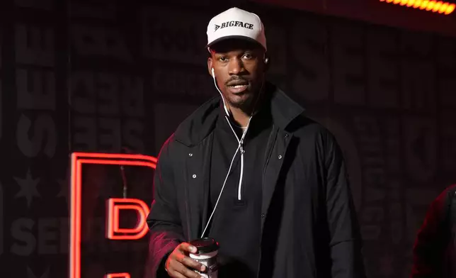 Golden State Warriors forward Jimmy Butler, left, arrives before an NBA basketball game against the Chicago Bulls, Saturday, Feb. 8, 2025, in Chicago. (AP Photo/Erin Hooley)
