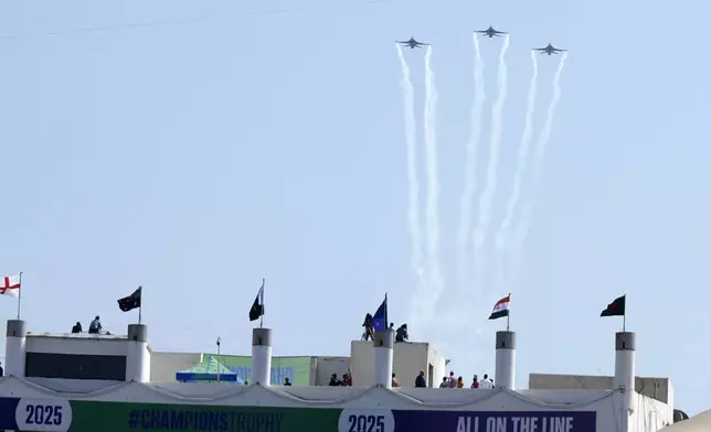 Pakistani fighter jets fly over the National Bank Stadium before start the ICC Champions Trophy cricket match between Pakistan and New Zealand, in Karachi, Pakistan Wednesday, Feb. 19, 2025. (AP Photo/Fareed Khan)