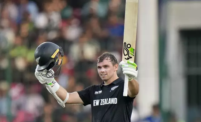 New Zealand's Tom Latham celebrates after scoring century during the ICC Champions Trophy cricket match between Pakistan and New Zealand, in Karachi, Pakistan Wednesday, Feb. 19, 2025. (AP Photo/Anjum Naveed)