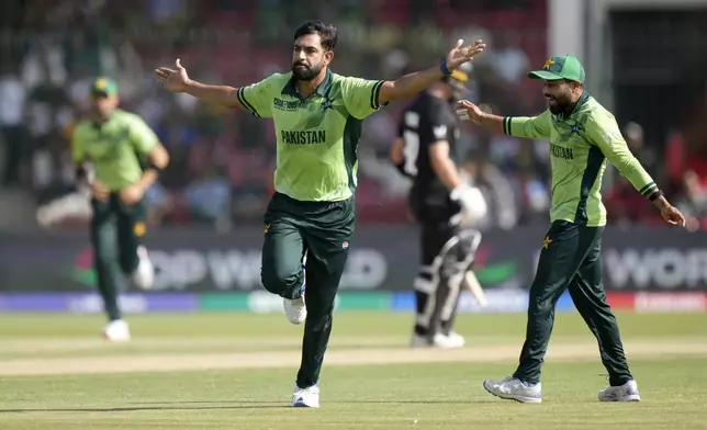 Pakistan's Haris Rauf, center, celebrates after taking the wicket of New Zealand's Daryl Mitchell during the ICC Champions Trophy cricket match between Pakistan and New Zealand, in Karachi, Pakistan Wednesday, Feb. 19, 2025. (AP Photo/Anjum Naveed)