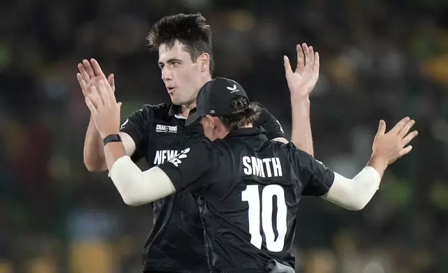 New Zealand's Will O' Rourke, back, celebrates with teammate after taking the wicket of Pakistan's Saud Shakeel during the ICC Champions Trophy cricket match between Pakistan and New Zealand, in Karachi, Pakistan Wednesday, Feb. 19, 2025. (AP Photo/Anjum Naveed)