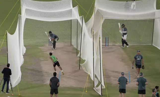 New Zealand's Daryl Mitchell, left, and teammates attend a practice session for the ICC Champions Trophy, in Karachi, Pakistan Tuesday, Feb. 18, 2025. (AP Photo/Fareed Khan)