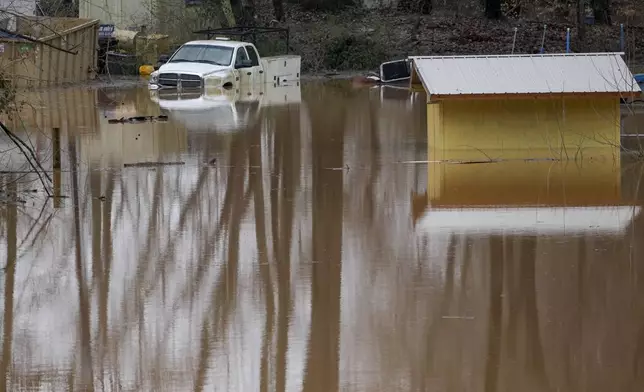 A truck sits in flood waters along the Cumberland River, Sunday, Feb. 16, 2025, in Clarksville, Tenn. (AP Photo/George Walker IV)