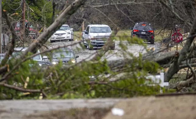 People drive around to view storm damage in east Tuscumbia, Ala., Sunday, Feb. 16, 2025. (dan Busey/The TimesDaily via AP)