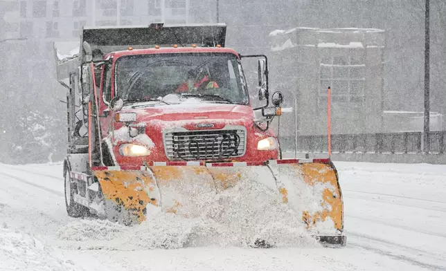 A plow clears a city bridge during a snowstorm in Montreal, Sunday, Feb. 16, 2025. (Graham Hughes/The Canadian Press via AP)