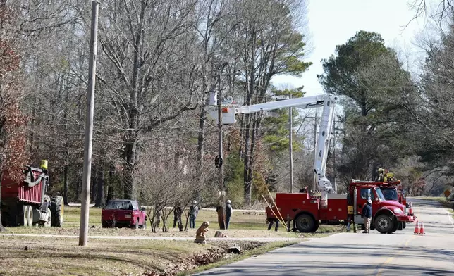 Crews with Tombigbee Electric continue to restore power to homes along Lee County Rd 154 after Saturday's severe weather hit the region in Shannon Miss., Monday, Feb. 17, 2025. (Thomas Wells/The Northeast Mississippi Daily Journal via AP)