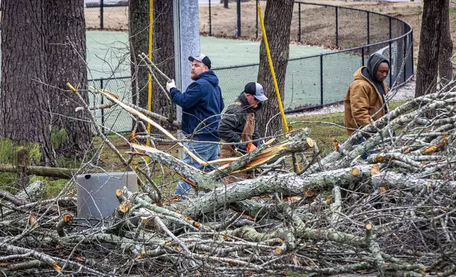 Muscle Shoals street department workers break down downed trees after severe weather hit at Gattman Park in Muscle Shoals, Ala., Sunday, Feb. 16, 2025. (Dan Busey/The TimesDaily via AP)