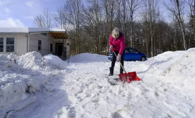 Janis Broom shovels the snow from her driveway on Monday, Feb. 17, 2025, Brattleboro, Vt., after a winter storm on Sunday. (Kristopher Radder/The Brattleboro Reformer via AP)