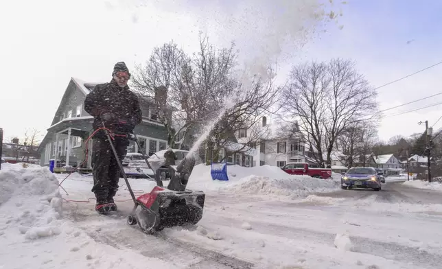 Jim Verzino uses a snowblower to clear the driveway on Monday, Feb. 17, 2025, Brattleboro, Vt., after a winter storm on Sunday. (Kristopher Radder/The Brattleboro Reformer via AP)