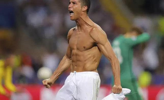 FILE - Real Madrid's Cristiano Ronaldo celebrates after scoring the winning penalty shootout during the Champions League final soccer match between Real Madrid and Atletico Madrid at the San Siro stadium in Milan, Italy, Saturday, May 28, 2016. (AP Photo/Manu Fernandez, File)