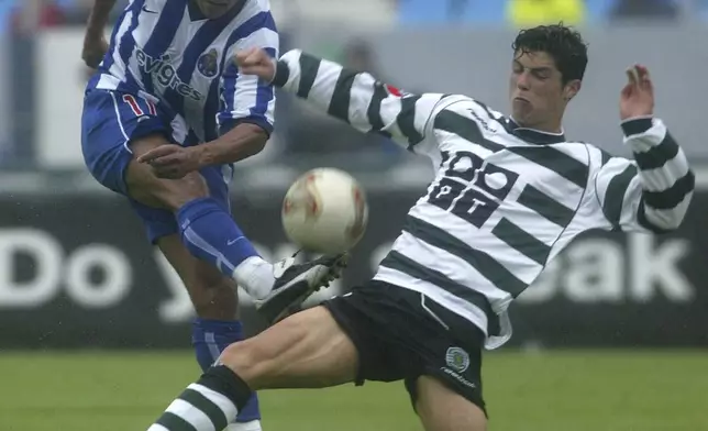 FILE - Sporting's Cristiano Ronaldo, right, fights for the ball against FC Porto's Derlei Silva during the last Portuguese SuperLeague 2002/03 match at Antas stadium in Oporto, Portugal, Sunday, June 1, 2003. (AP Photo/Paulo Duarte, File)