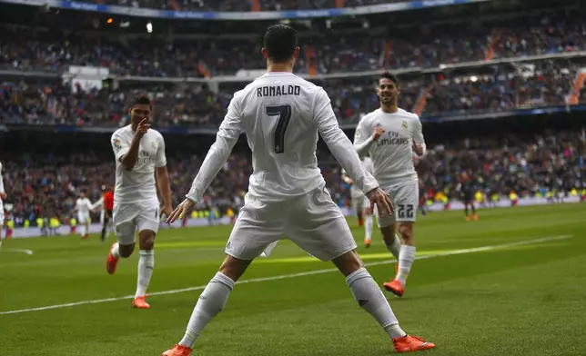 FILE - Real Madrid's Cristiano Ronaldo celebrates with teammates after scoring a goal against Celta during a Spanish La Liga soccer match between Real Madrid and Celta Vigo at the Santiago Bernabeu stadium in Madrid, Saturday, March 5, 2016. (AP Photo/Francisco Seco, File)