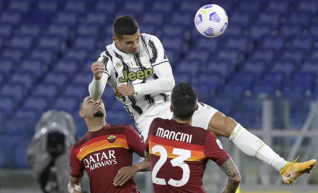 FILE - Juventus' Cristiano Ronaldo, top, heads the ball to scores his side's second goal during the Italian Serie A soccer match between Roma and Juventus at Rome's Olympic stadium, Sunday, Sept. 27, 2020. (AP Photo/Gregorio Borgia, File)
