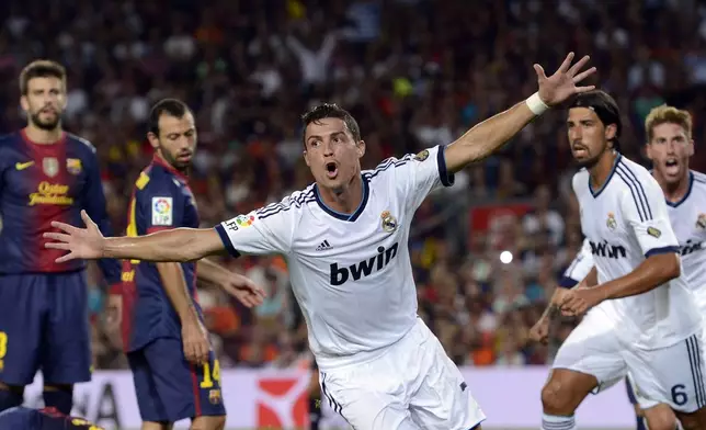 FILE - Real Madrid's Cristiano Ronaldo from Portugal, center, reacts after scoring against FC Barcelona during a Spanish Supercup, first leg soccer match at the Camp Nou stadium in Barcelona, Spain, Thursday, Aug. 23, 2012. (AP Photo/Manu Fernandez, File)