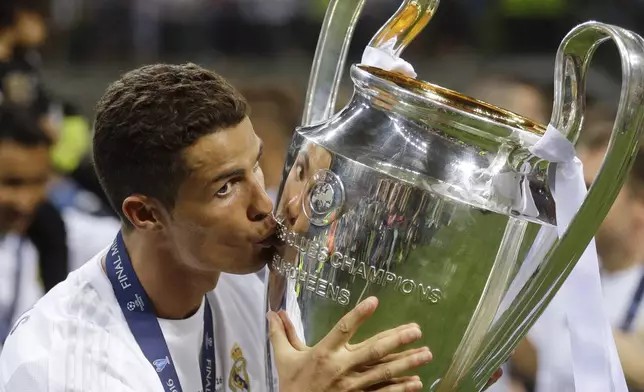 FILE - Real Madrid's Cristiano Ronaldo kisses the trophy after the Champions League final soccer match between Real Madrid and Atletico Madrid at the San Siro stadium in Milan, Italy, Saturday, May 28, 2016. (AP Photo/Andrew Medichini, File)