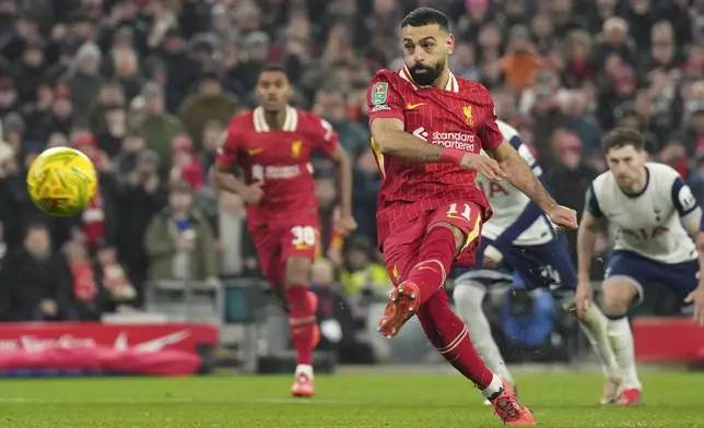 Liverpool's Mohamed Salah scores the second goal from the penalty spot during the English League Cup semifinal second leg soccer match between Liverpool and Tottenham Hotspur at Anfield Stadium in Liverpool, England, Thursday, Feb. 6, 2025. (AP Photo/Jon Super)