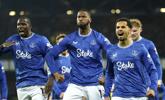 Everton's Beto, centre, celebrates with teammates after scoring his side's opening goal during the English Premier League soccer match between Everton and Liverpool, Liverpool, England, Wednesday, Feb.12, 2025. (AP Photo/Dave Thompson)