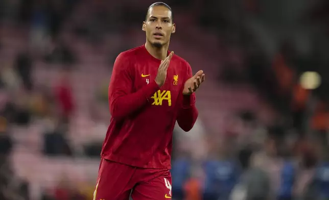 Liverpool's Virgil van Dijk applauds as he warms-up before the English League Cup semifinal second leg soccer match between Liverpool and Tottenham Hotspur at Anfield Stadium in Liverpool, England, Thursday, Feb. 6, 2025. (AP Photo/Jon Super)