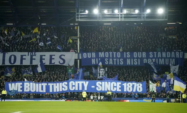 Supporters of Everton hold banners ahead of the English Premier League soccer match between Everton and Liverpool, Liverpool, England, Wednesday, Feb.12, 2025. (AP Photo/Dave Thompson)