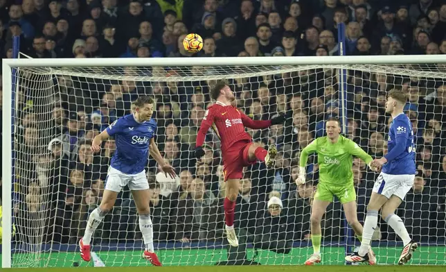 Liverpool's Alexis Mac Allister, centre, scores his side's opening goal during the English Premier League soccer match between Everton and Liverpool, Liverpool, England, Wednesday, Feb.12, 2025. (AP Photo/Dave Thompson)